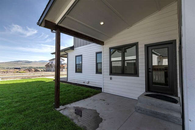 4961 England Blvd, Missoula, MT 59808 - view of side of home with a yard, a shingled roof, and an attached garage