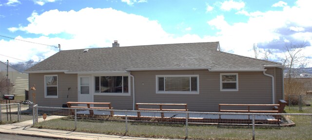 820 Lexington Ave, Butte, MT 59701 - rear view of property featuring a chimney, a fenced backyard, and a shingled roof