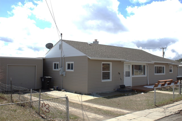 820 Lexington Ave, Butte, MT 59701 - view of front of house featuring a garage, roof with shingles, a chimney, and a fenced backyard