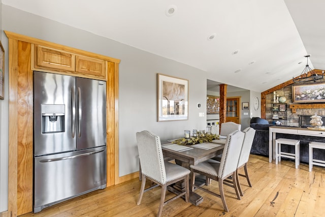 11 Wilson Butte Rd, Great Falls, MT 59405 - dining space with vaulted ceiling, light wood-type flooring, and baseboards