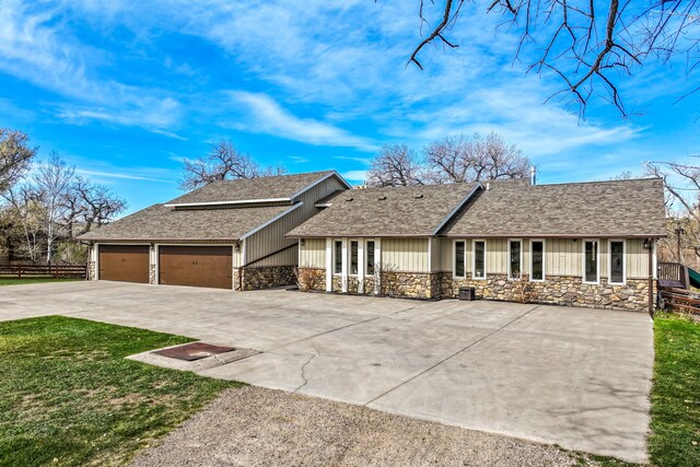 11 Wilson Butte Rd, Great Falls, MT 59405 - single story home featuring stone siding, concrete driveway, an attached garage, and roof with shingles