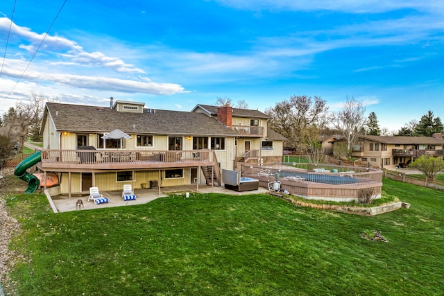 11 Wilson Butte Rd, Great Falls, MT 59405 - rear view of property with a patio, stairway, a wooden deck, a yard, and a chimney