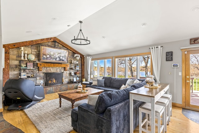 11 Wilson Butte Rd, Great Falls, MT 59405 - living area featuring light wood-type flooring, a fireplace, vaulted ceiling, and baseboards