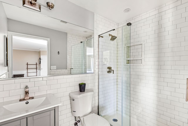 11 Wilson Butte Rd, Great Falls, MT 59405 - bathroom with toilet, tile walls, vanity, tiled shower, and ornamental molding