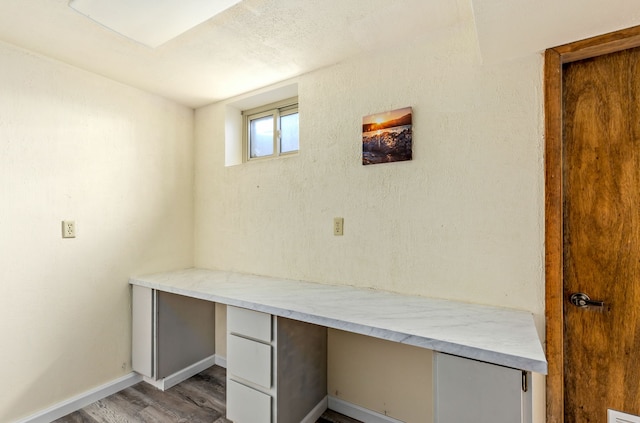 11 Wilson Butte Rd, Great Falls, MT 59405 - unfurnished office featuring built in desk, light wood-style floors, and baseboards