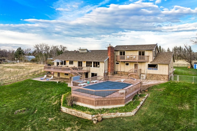 11 Wilson Butte Rd, Great Falls, MT 59405 - rear view of property featuring a deck, a patio area, a chimney, and roof with shingles