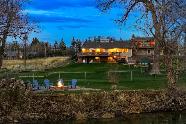 11 Wilson Butte Rd, Great Falls, MT 59405 - rear view of house with a fire pit, a patio, and a water view