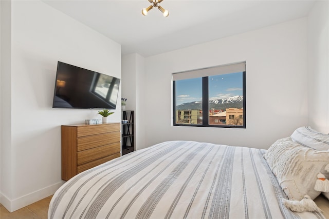 bedroom with baseboards and wood finished floors