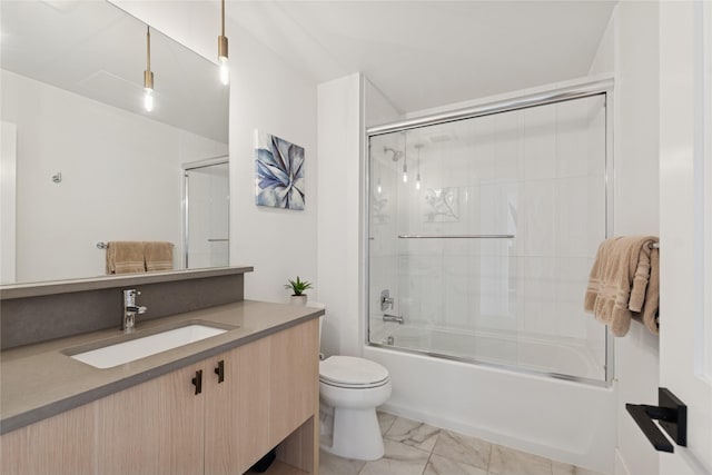 full bath featuring vanity, bath / shower combo with glass door, marble finish floor, and toilet