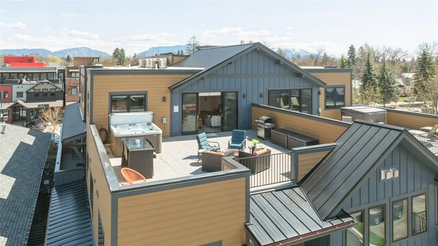 back of house featuring an outdoor living space, board and batten siding, and a mountain view