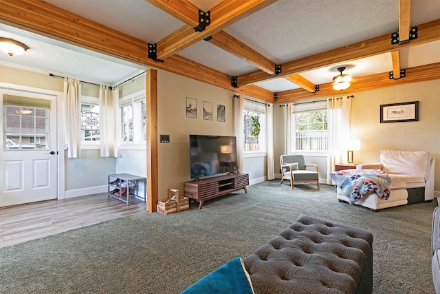living area with baseboards, coffered ceiling, and beam ceiling