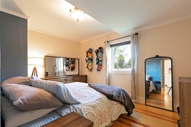 bedroom featuring ornamental molding and light wood-style flooring