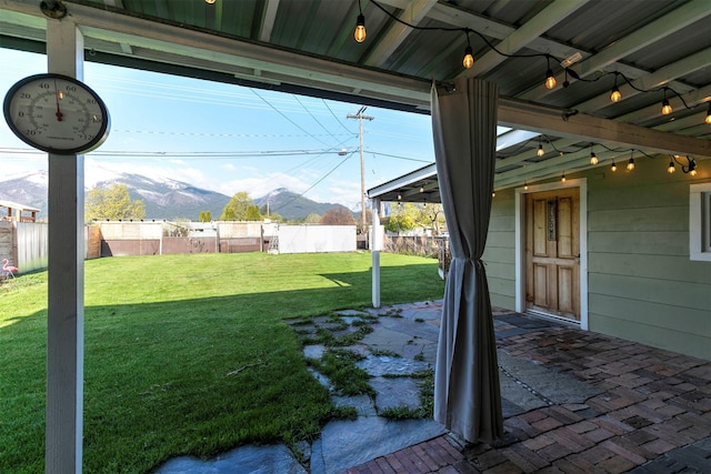 view of yard with a fenced backyard and a mountain view