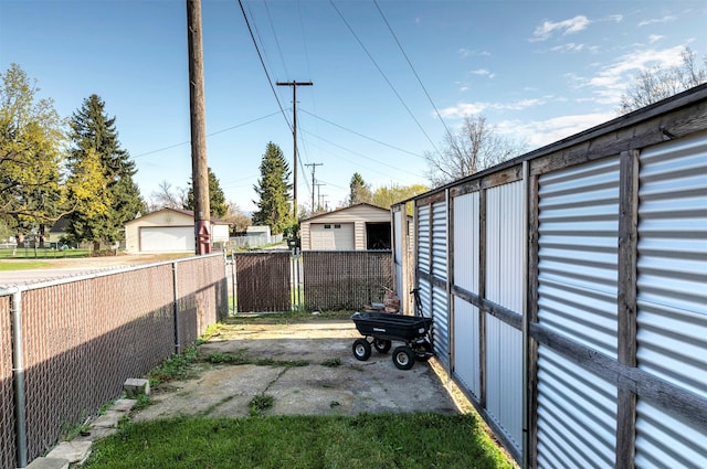 view of yard featuring fence and a garage