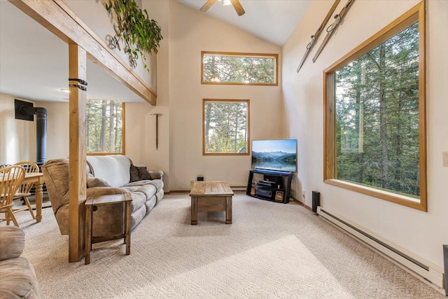 carpeted living area with a baseboard radiator, a ceiling fan, lofted ceiling, and a wood stove