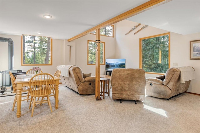 carpeted living room with plenty of natural light, a wood stove, and recessed lighting