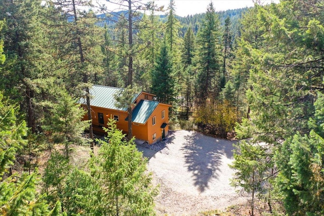 birds eye view of property featuring a view of trees