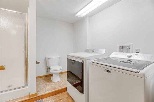 laundry room with light tile patterned floors, laundry area, and washer and clothes dryer