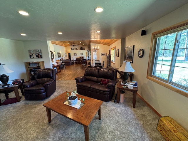 carpeted living room with recessed lighting, baseboards, and a notable chandelier