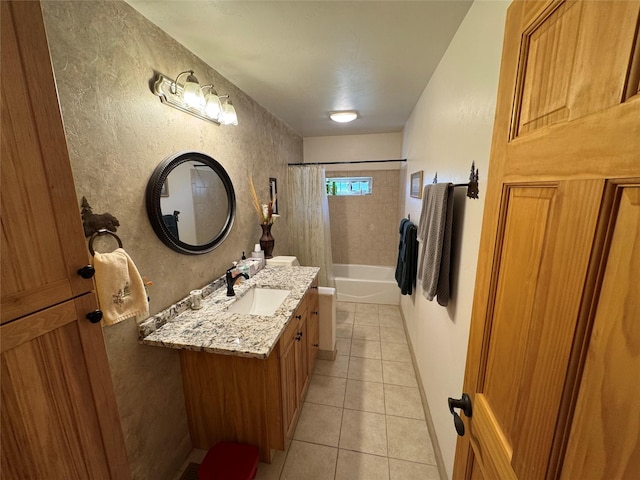 full bathroom featuring vanity, tile patterned flooring, a textured wall, and shower / bathtub combination with curtain