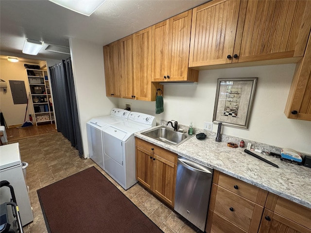 washroom with a sink, separate washer and dryer, laundry area, and electric panel
