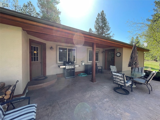 view of patio featuring outdoor dining area and a grill