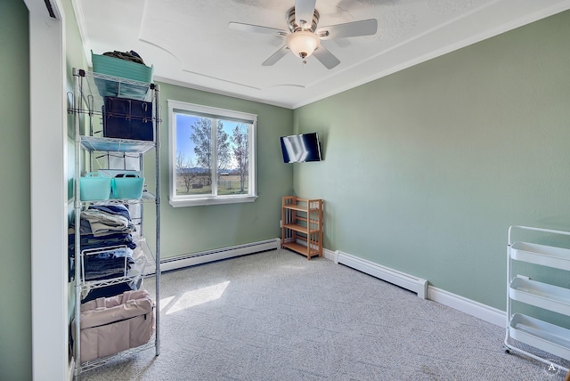 interior space featuring crown molding, ceiling fan, baseboard heating, baseboards, and a baseboard heating unit
