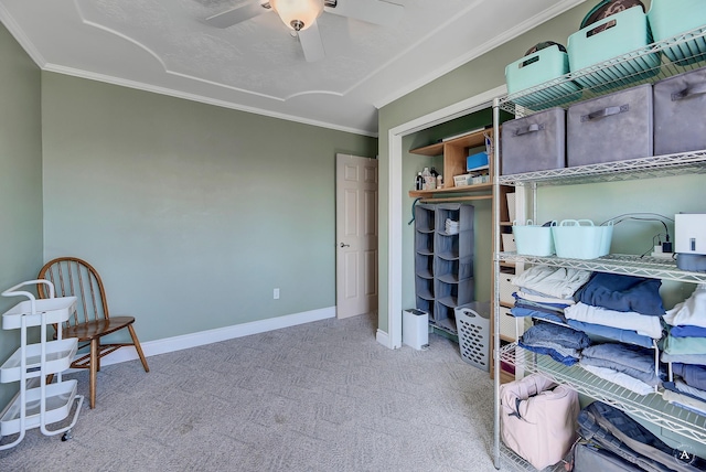 interior space with crown molding, baseboards, and ceiling fan