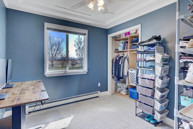 interior space featuring a ceiling fan, baseboards, a baseboard radiator, a closet, and carpet flooring