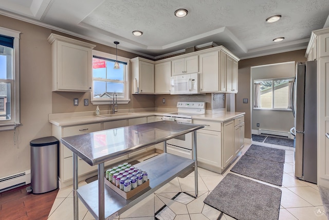 kitchen featuring baseboard heating, a sink, white appliances, a baseboard radiator, and a tray ceiling