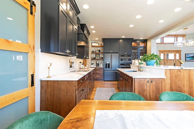 1207 Creek Crossing Rd, Missoula, MT 59802 - kitchen featuring built in fridge, light countertops, glass insert cabinets, recessed lighting, and decorative backsplash