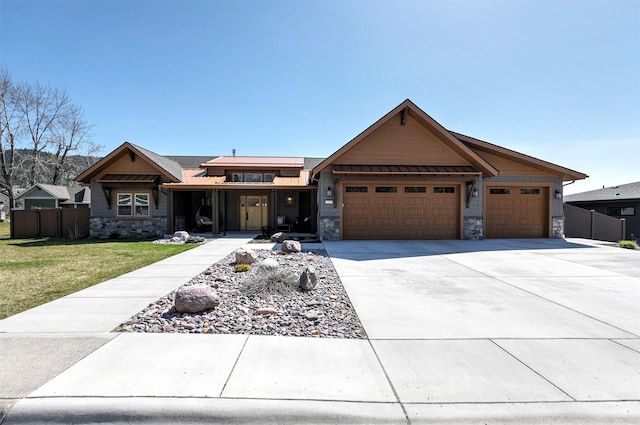 1207 Creek Crossing Rd, Missoula, MT 59802 - view of front of home with stone siding, a garage, and concrete driveway
