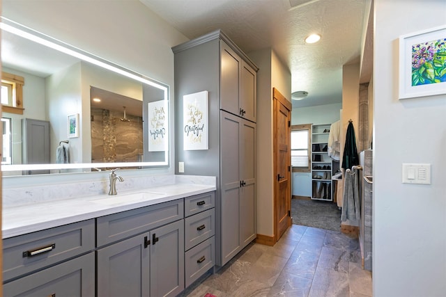 1207 Creek Crossing Rd, Missoula, MT 59802 - full bathroom featuring vanity, a textured ceiling, recessed lighting, a spacious closet, and a shower