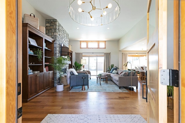 1207 Creek Crossing Rd, Missoula, MT 59802 - living area featuring hardwood / wood-style floors, healthy amount of natural light, a chandelier, a high ceiling, and recessed lighting