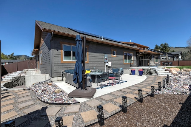 1207 Creek Crossing Rd, Missoula, MT 59802 - rear view of house featuring a patio area and solar panels