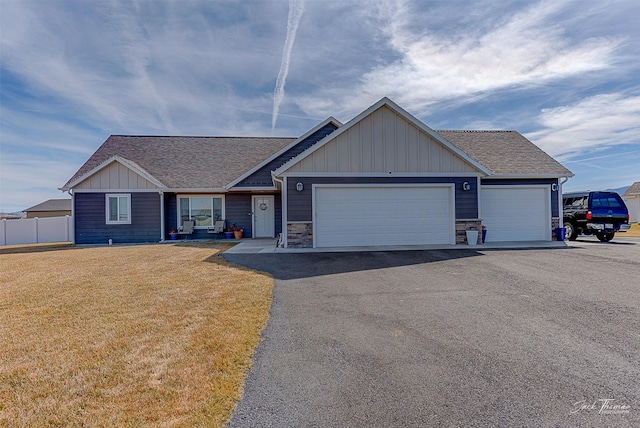 3875 Saint Marys Rd, East Helena, MT 59635 - view of front of property with a garage, asphalt driveway, a shingled roof, and board and batten siding