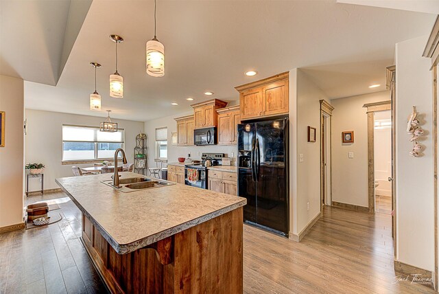 3875 Saint Marys Rd, East Helena, MT 59635 - kitchen with black appliances, wood finished floors, a center island with sink, and recessed lighting