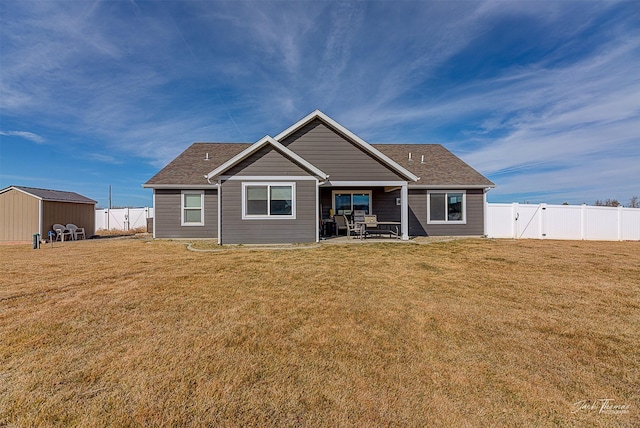 3875 Saint Marys Rd, East Helena, MT 59635 - back of property featuring a fenced backyard, a patio area, a storage unit, and a shingled roof