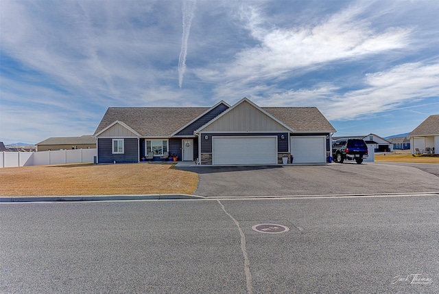 3875 Saint Marys Rd, East Helena, MT 59635 - ranch-style home featuring an attached garage, board and batten siding, asphalt driveway, and a shingled roof