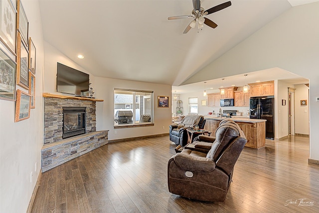 3875 Saint Marys Rd, East Helena, MT 59635 - living room featuring a stone fireplace, ceiling fan, wood-type flooring, high vaulted ceiling, and recessed lighting
