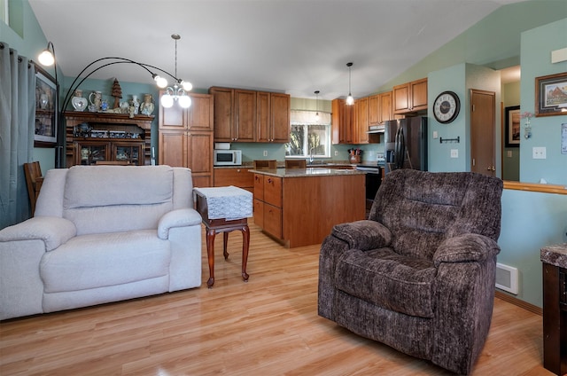 103 Tamarack Woods Dr, Lakeside, MT 59922 - kitchen with light wood-style floors, open floor plan, white microwave, and fridge with ice dispenser