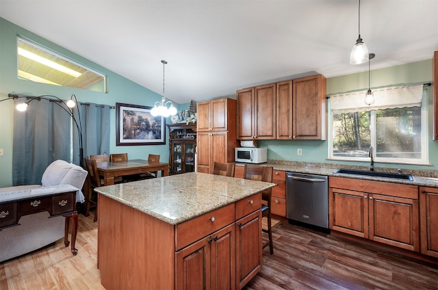 103 Tamarack Woods Dr, Lakeside, MT 59922 - kitchen with brown cabinets, a sink, dishwasher, white microwave, and vaulted ceiling