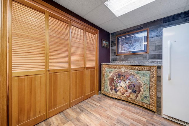 103 Tamarack Woods Dr, Lakeside, MT 59922 - bar featuring freestanding refrigerator, wooden walls, a paneled ceiling, and light wood finished floors