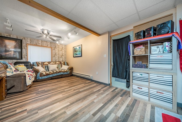 103 Tamarack Woods Dr, Lakeside, MT 59922 - living room featuring track lighting, wood finished floors, baseboards, baseboard heating, and a ceiling fan