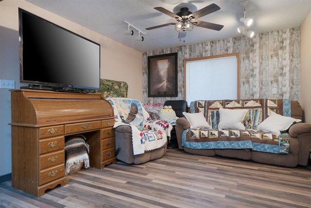 103 Tamarack Woods Dr, Lakeside, MT 59922 - interior space with wooden walls, a ceiling fan, rail lighting, and wood finished floors