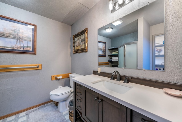 103 Tamarack Woods Dr, Lakeside, MT 59922 - full bathroom with vanity, a shower with door, a textured wall, toilet, and baseboards