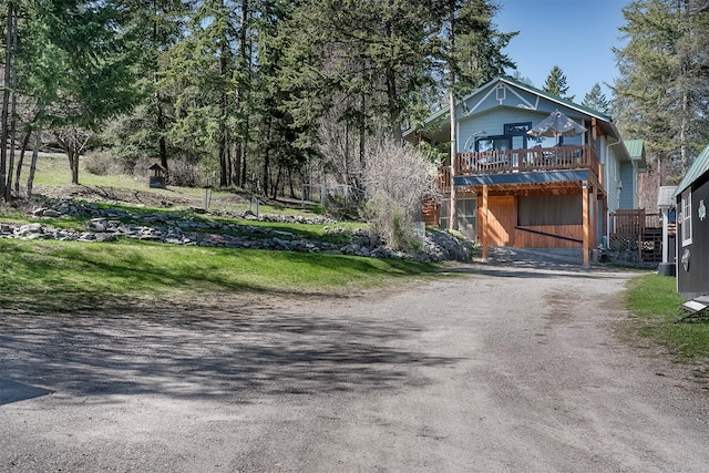 103 Tamarack Woods Dr, Lakeside, MT 59922 - view of front of home featuring dirt driveway and a wooden deck