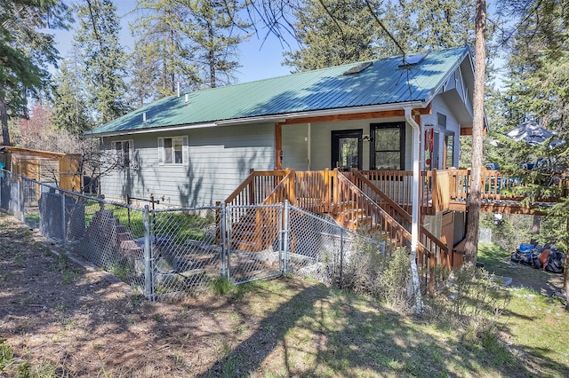 103 Tamarack Woods Dr, Lakeside, MT 59922 - view of outbuilding with a porch, stairway, fence private yard, and a gate