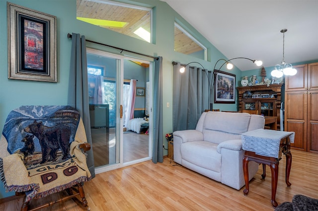 103 Tamarack Woods Dr, Lakeside, MT 59922 - living area featuring a chandelier, vaulted ceiling, and light wood-style floors