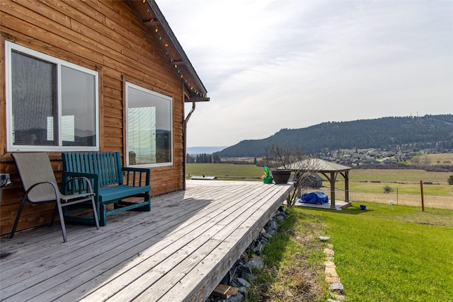 deck with a lawn, a mountain view, and a gazebo